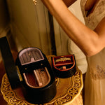 Close-up of a decorative box with a mirror on a small table, with a person partially visible in the background.