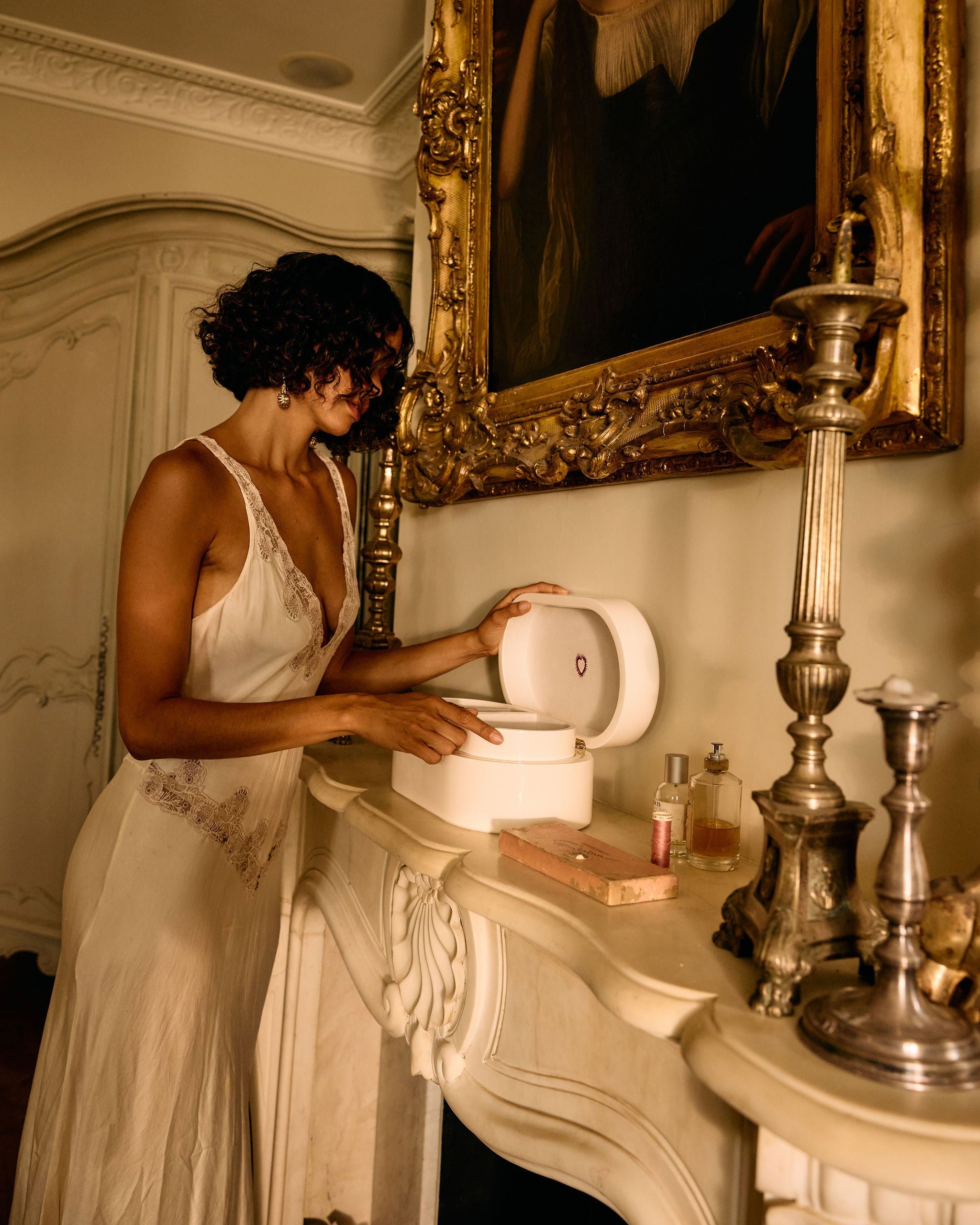 Woman in a white dress interacting with a toilet in an ornate room.