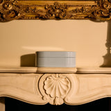Jewellery box on a mantelpiece with an ornate gold frame above