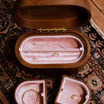Open wooden jewellery chest on a vintage rug