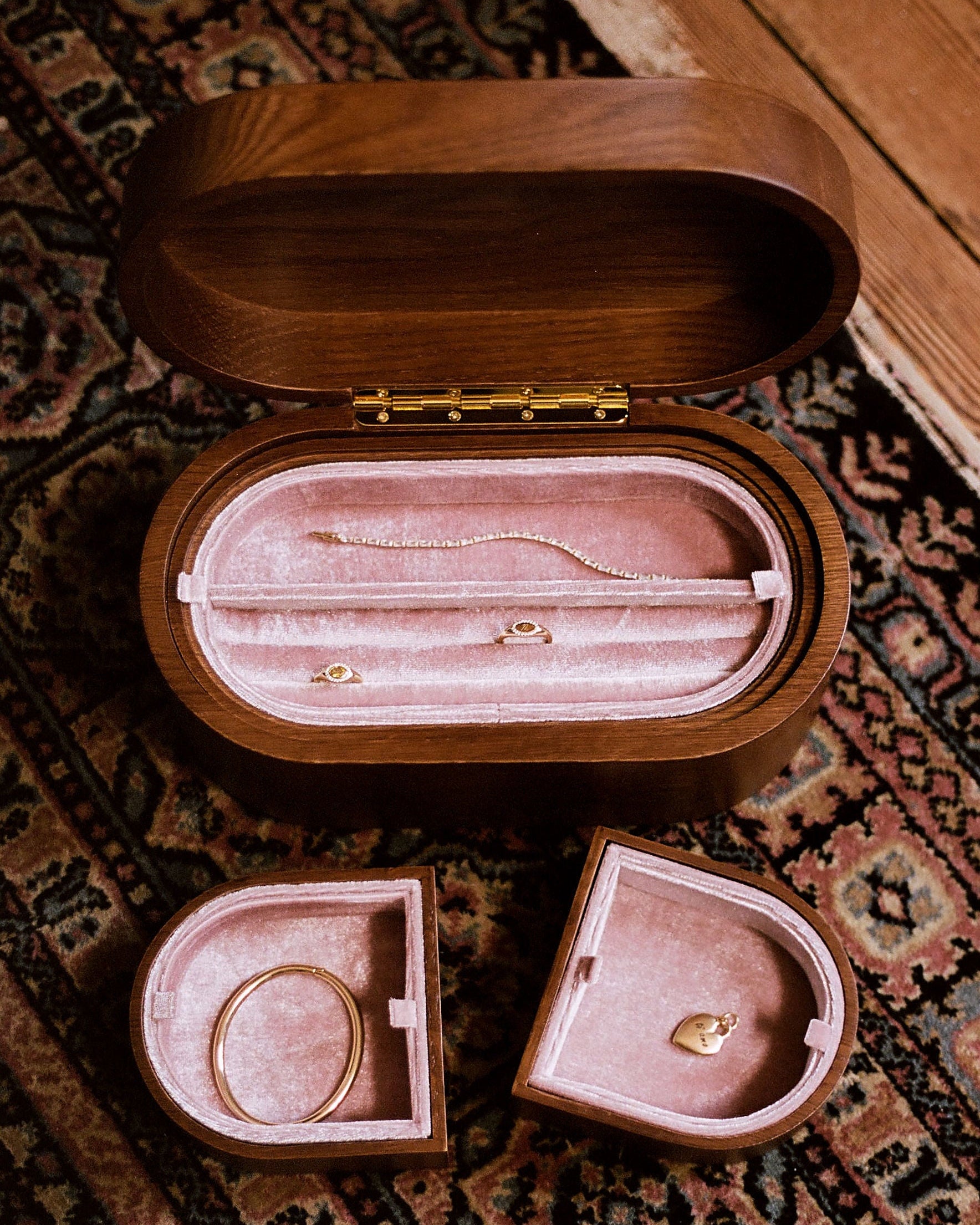 Open wooden jewellery chest on a vintage rug